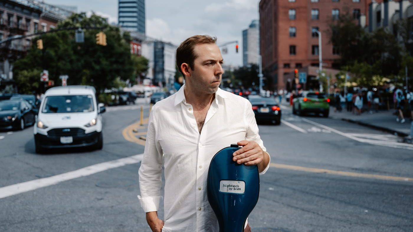 Brook Speltz on a NYC street with cello case