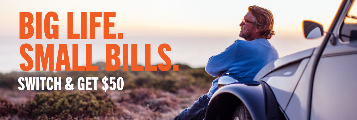 Man leaning against his car enjoying a nice sunset in the mountains with text reading 'Big Life. Small Bills. Switch and get $50'