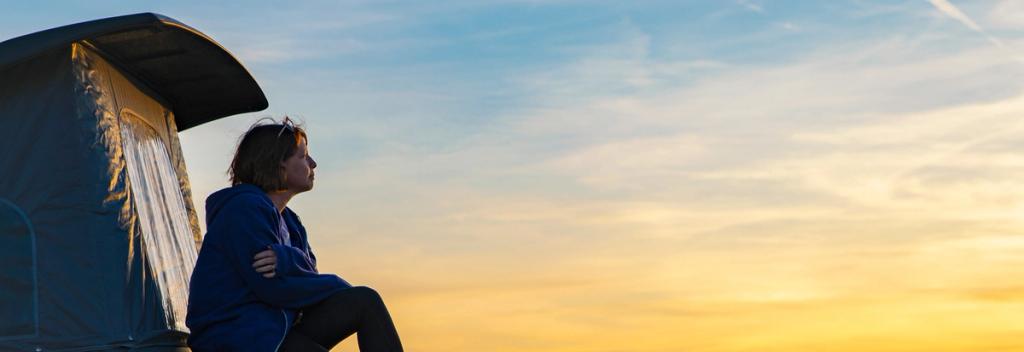 Woman looking off into the sunset.