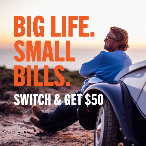 Man leaning against his car enjoying a nice sunset in the mountains with text reading 'Big Life. Small Bills. Switch and get $50'