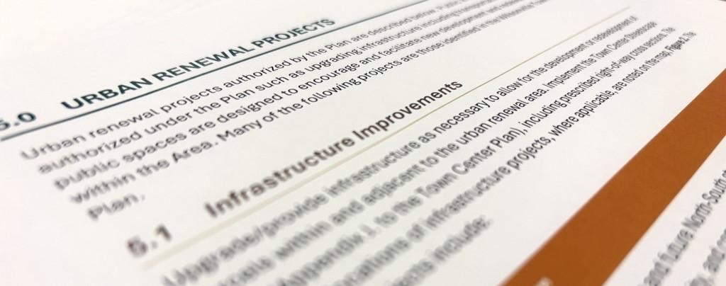 Close-up of a document page detailing "Urban Renewal Projects" and "Infrastructure Improvements."