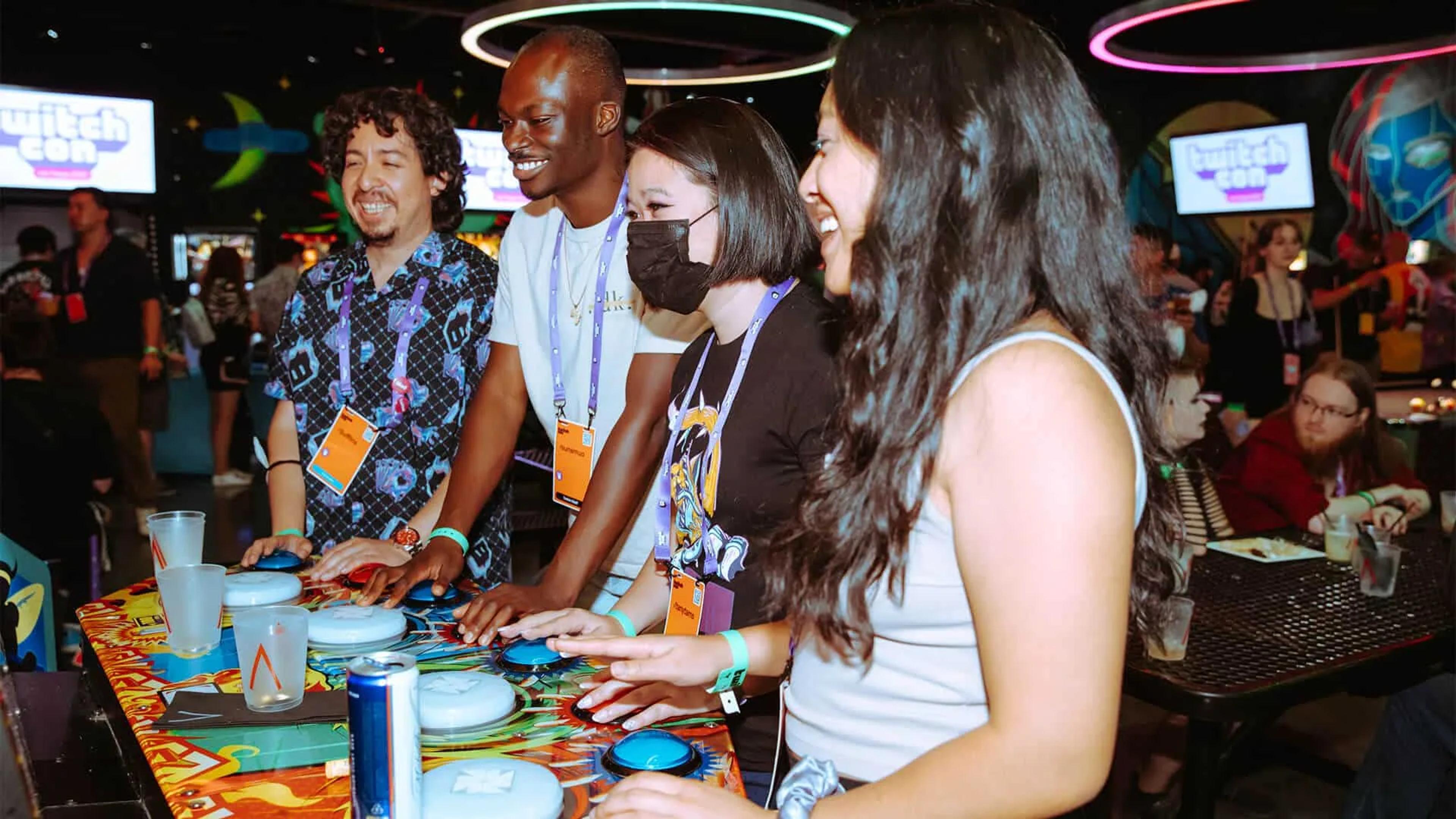 Group playing arcade game at Asylum
