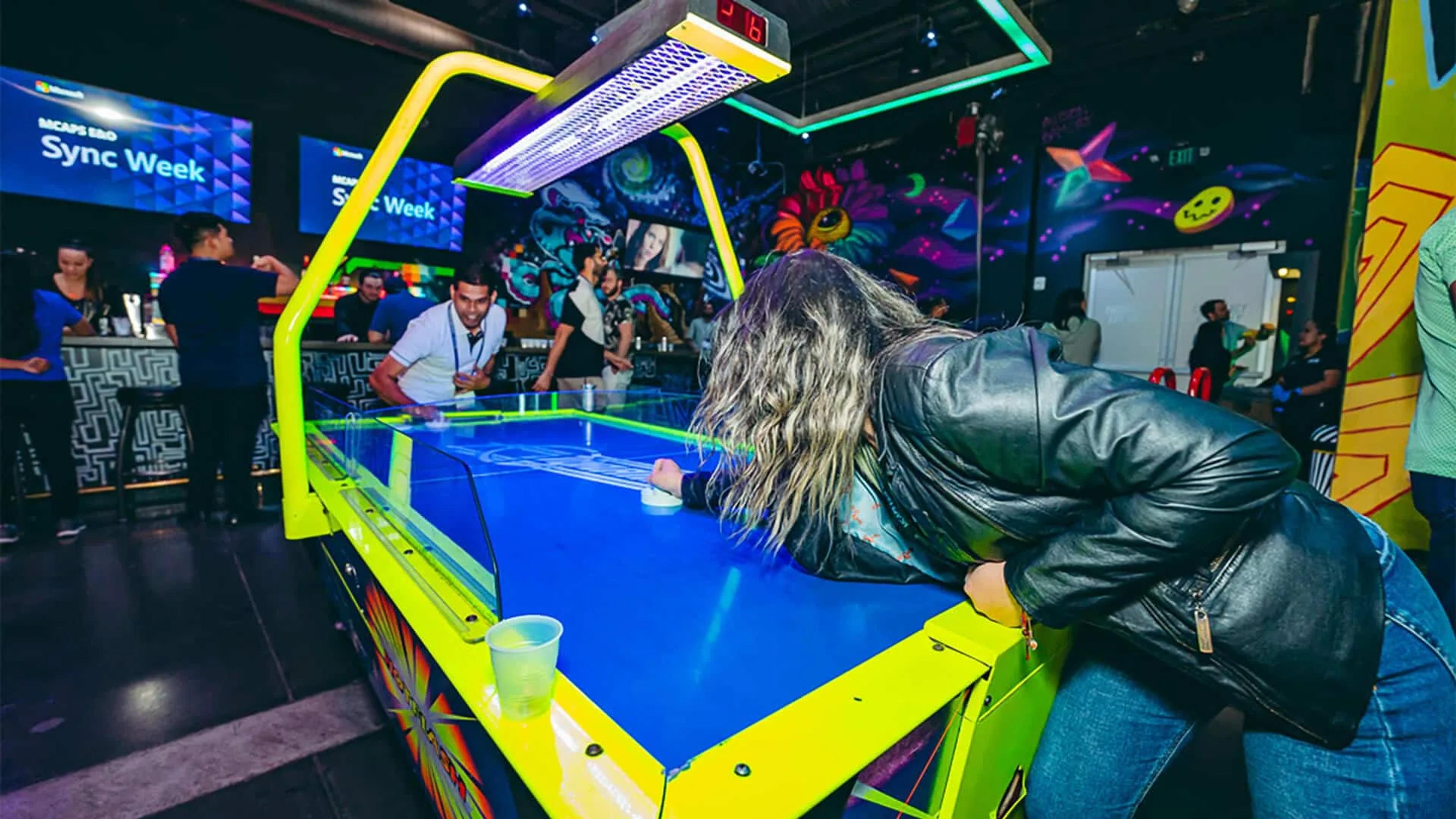 Playing air hockey at Asylum