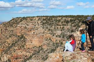 A family views scenery at the Grand Canyon.