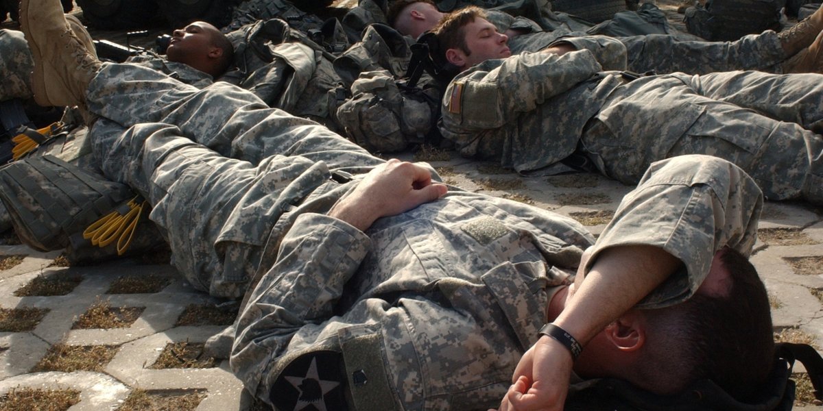 Soldiers sleeping on the floor in a bunker.