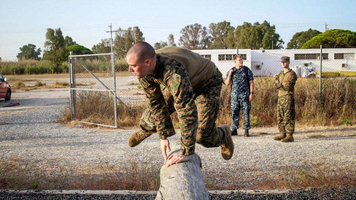 Soldier jumping over an postacle in a training exercise