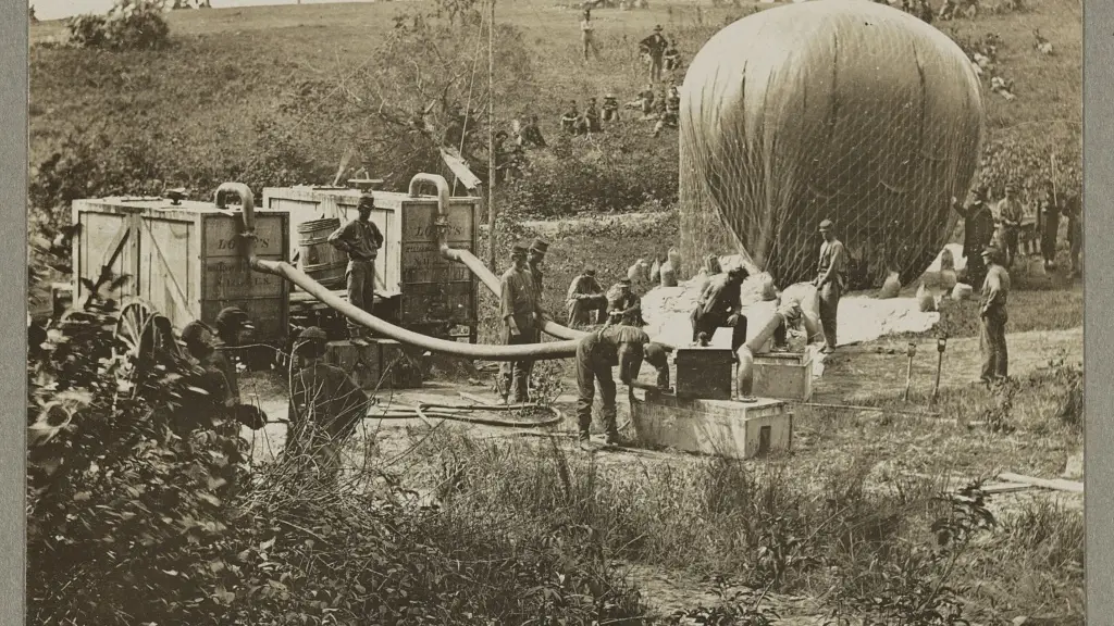 Vintage photo of men blowing up a war balloon