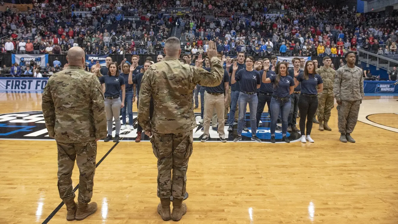 Airmen salute the flag.