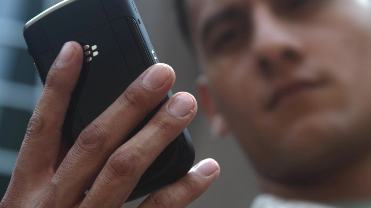 Close-up of a soldier holding a phone.