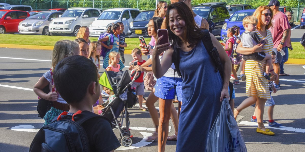 ZUSHI, Japan (Aug. 27, 2018) A parent takes a photo of her child on the first day of school at U.S. Fleet Activities (FLEACT) Yokosuka’s Ikego Elementary School.