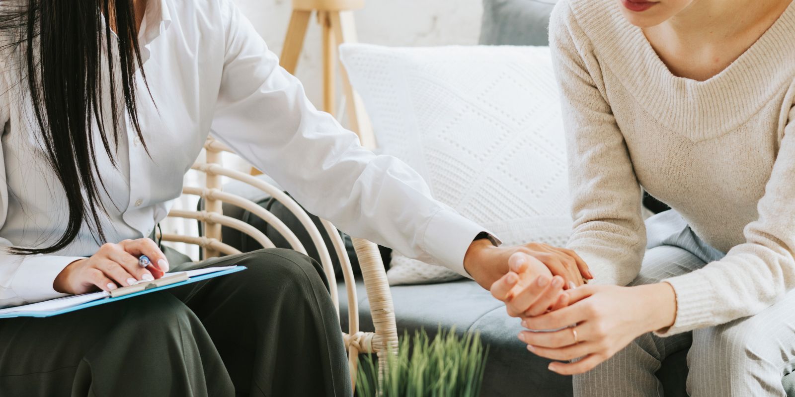 A young woman, nervous about her current therapy session, being comforted by her therapist.