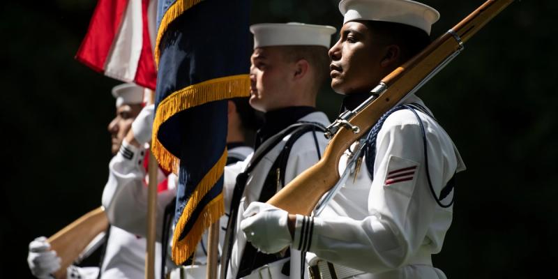 A color guard from the U.S. Navy Ceremonial Guard participates in a ceremony honoring the 107th anniversary of the founding of the Selective Service System Directorate (SSS) in Section 7 of Arlington National Cemetery, Arlington, VA.