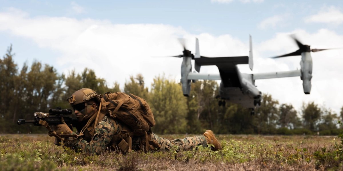 U.S. Marine Corps Lance Cpl. Efren Bonilla-Perez sets security for an MV-22 Osprey with Marine Medium Tilt Rotor Squadron (VMM) 268, Marine Aircraft Group 24, 1st Marine Aircraft Wing, during Force Design Integration Exercise at Dillingham Airfield.