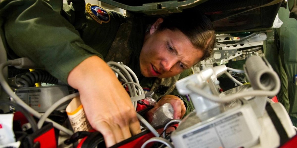 Air Force technician inspecting aircraft electronics during JRTC training.