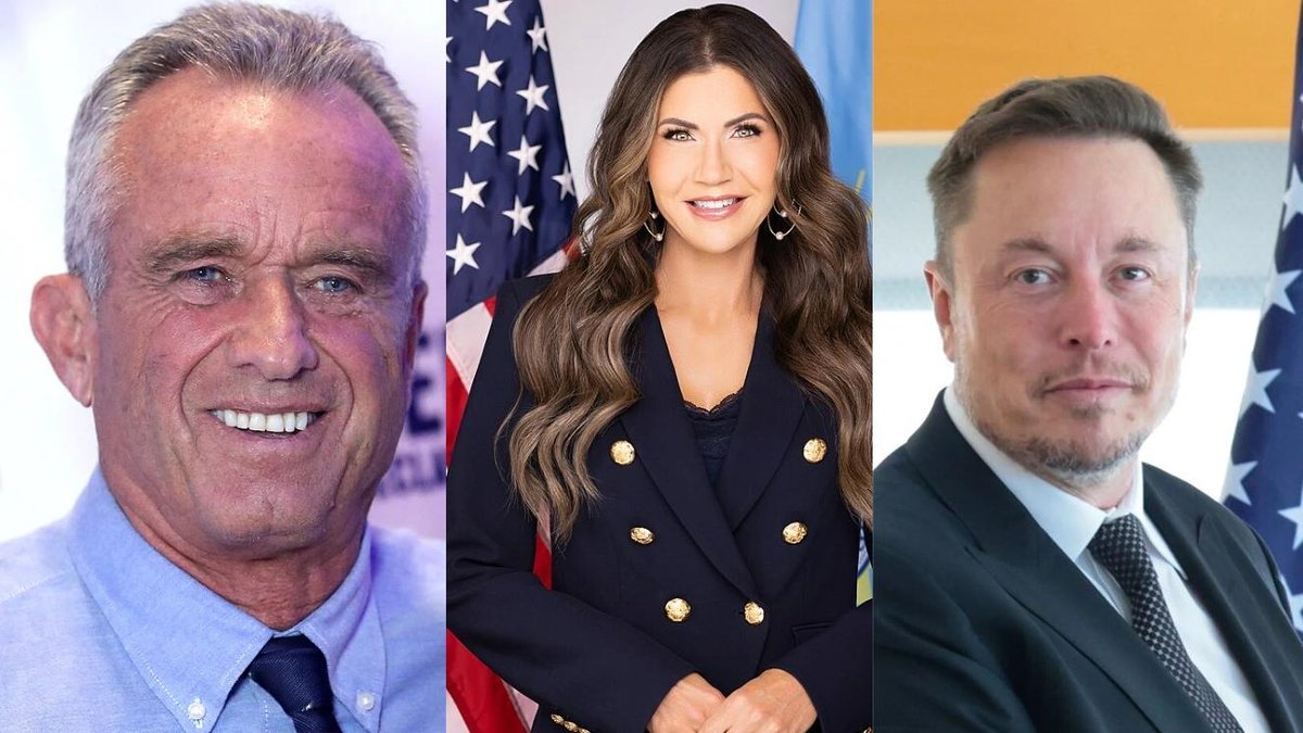 Three individuals in formal attire with U.S. flags in the background.