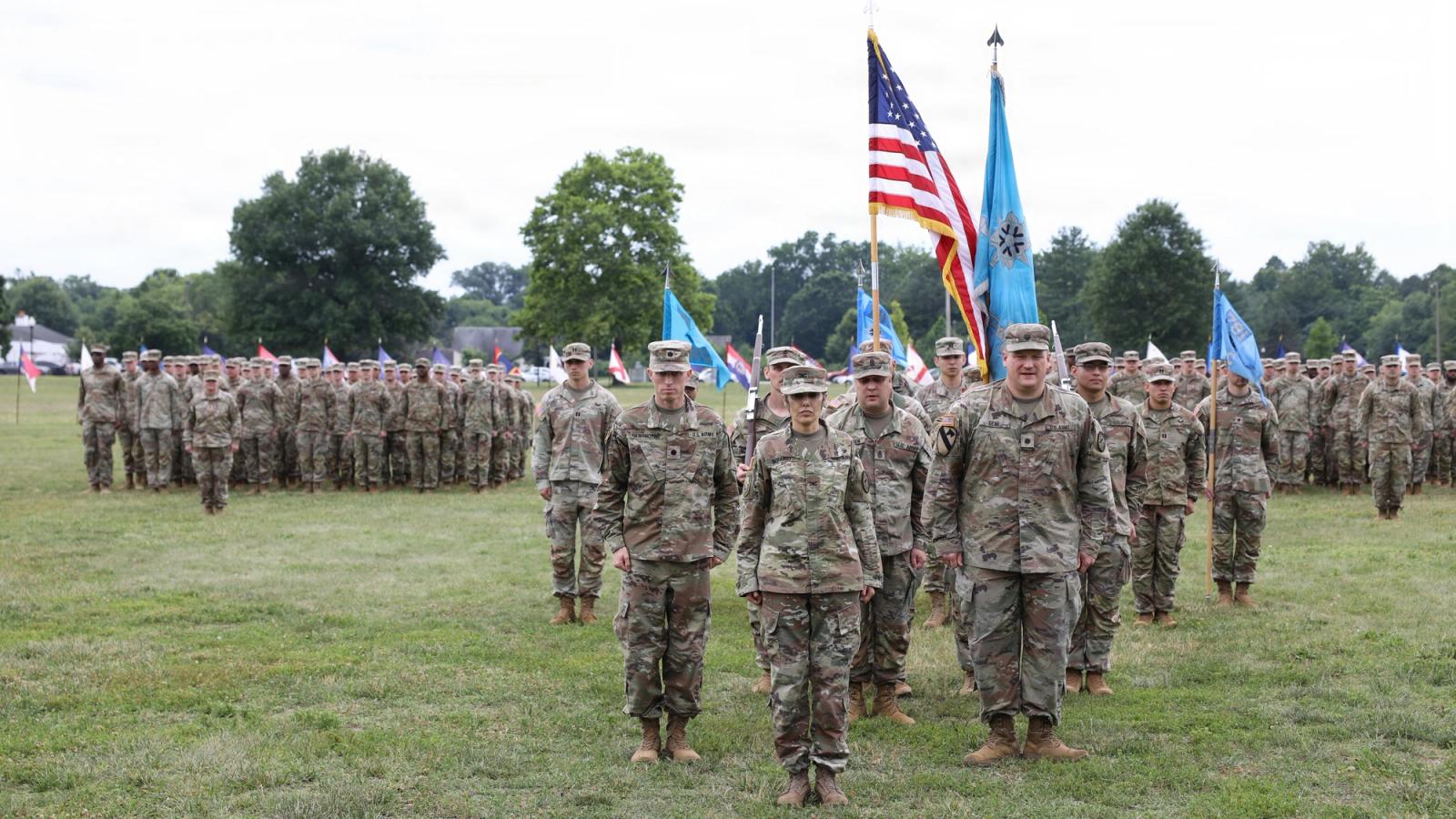 A platoon of soldiers stand in formation.