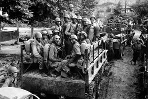 Vintage photo of Black soldiers in a truck in Korea.