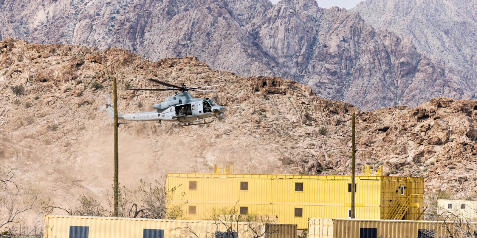 A helicopter lands over a bunker in a training mission.