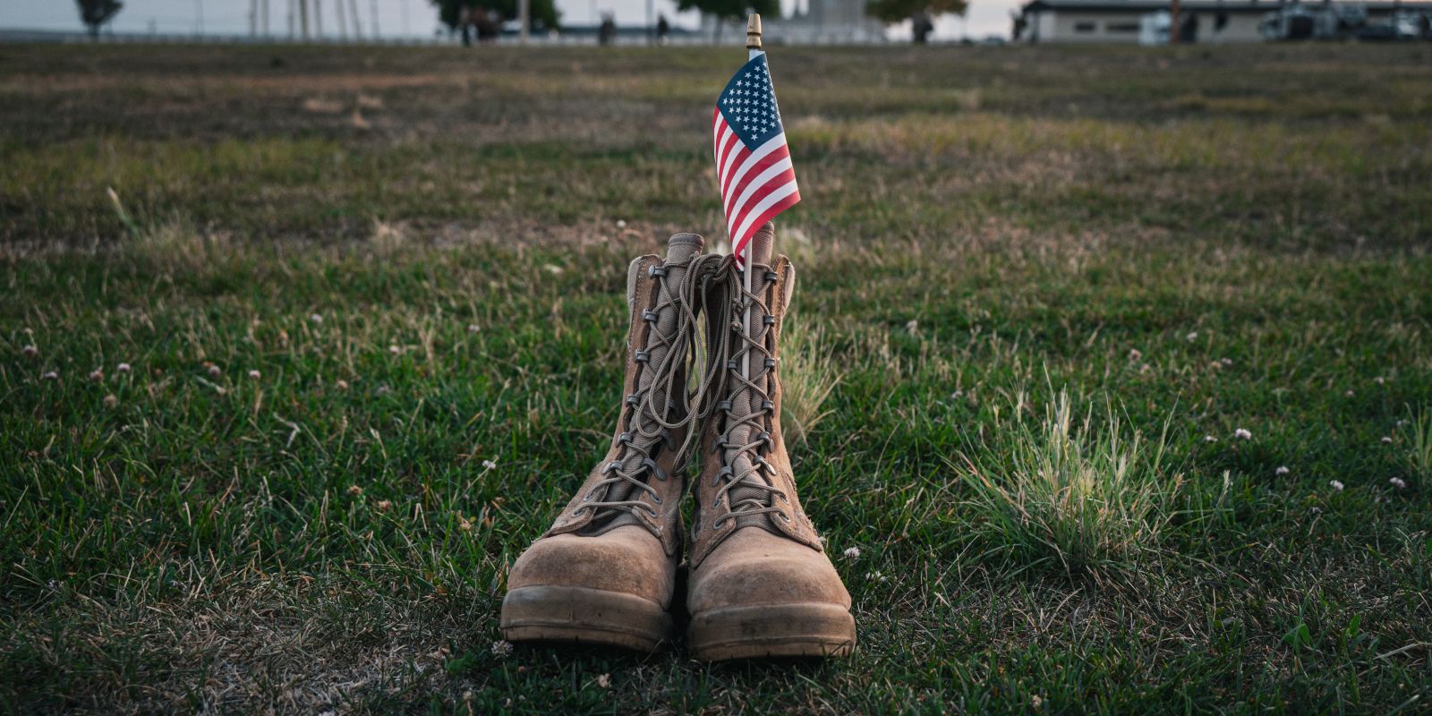 A pair of operational camouflage pattern boots sits in the grass around the 341st Force Support Squadron fitness center track during Malmstrom’s annual Ruck for Life Sept. 12, 2025, at Malmstrom Air Force Base, Mont.