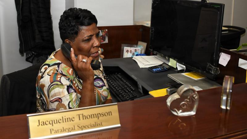 NNSY Code 107 Paralegal Specialist Jacqueline Thompson discusses a document needed for an upcoming review board.