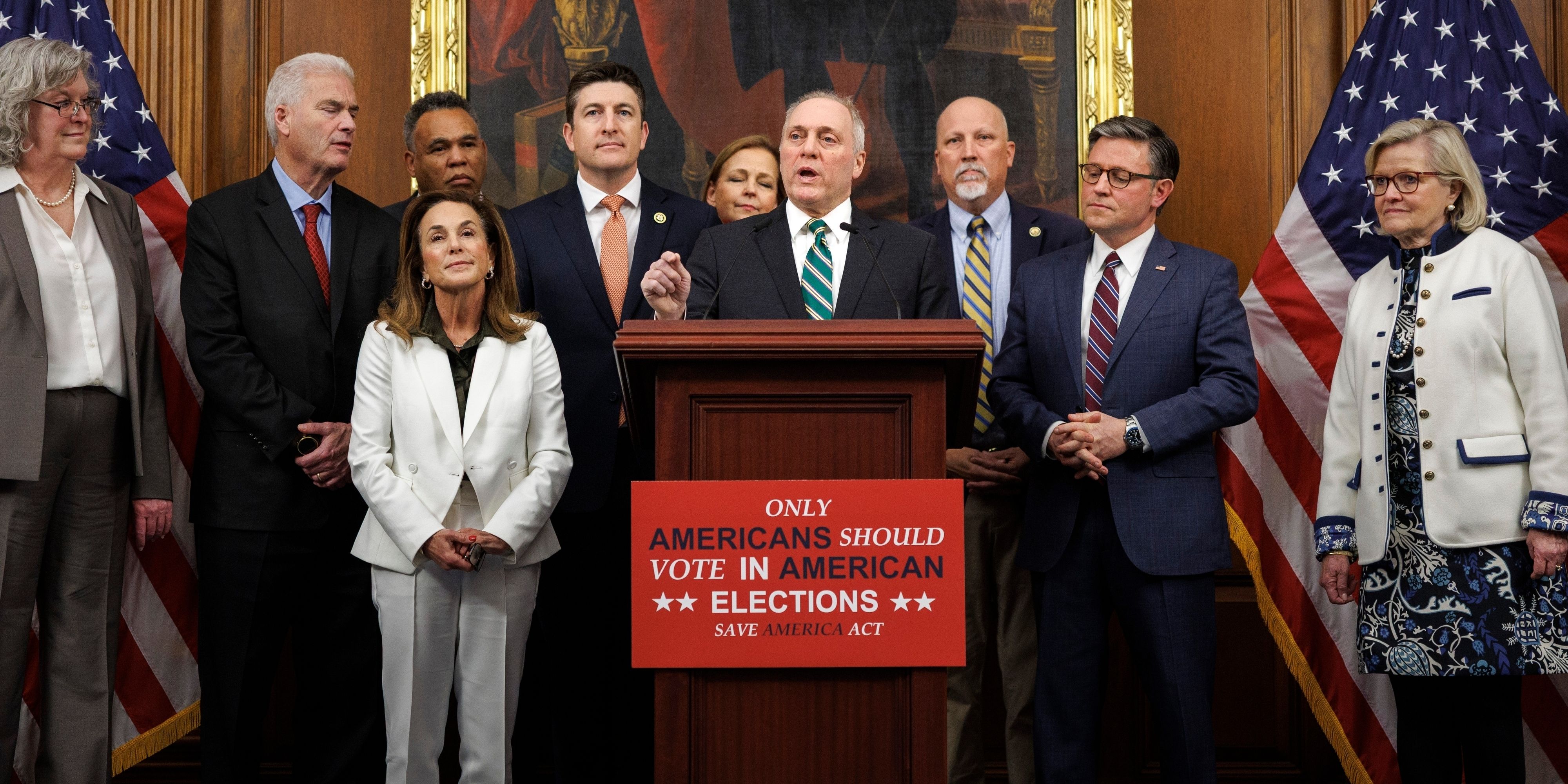 A group of Congressmen stand behind a podium announce the the SAVE Act.