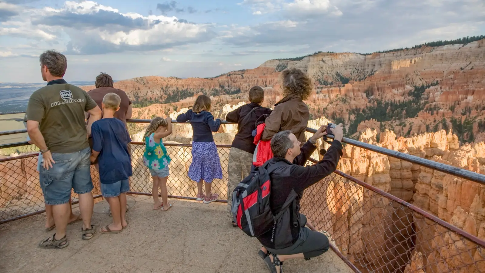 Families take pictures in a viewing area in a picturesque canyon.