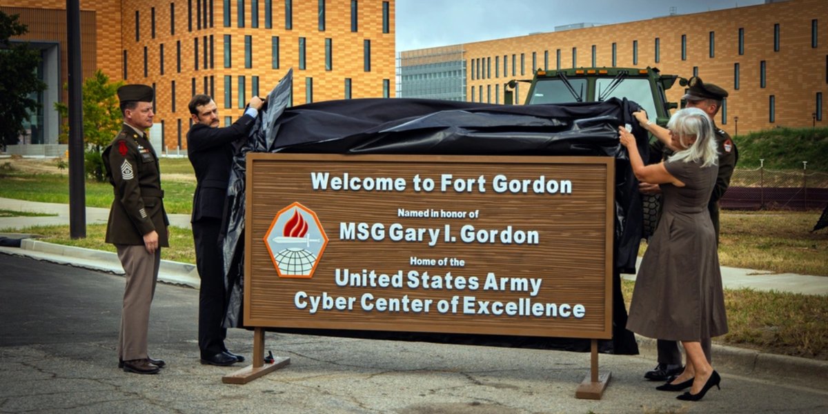 Maj. Gen. Ryan Janovi, Command Sgt. Maj. Timothy McGuir, Carmen Drake-Owens, and Ian Gordon unveil the Fort Gordon gate sign during the redesignation ceremony.
