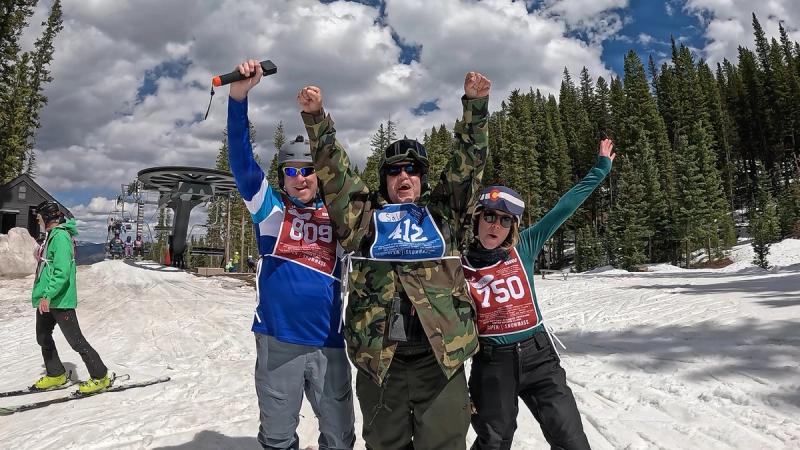 U.S. Air Force Veteran Salvador Vasquez (center) raises his arms in celebration with ski instructors Bruce Tubbs (left) and Molly Nickel (right) after a successful ski run at Snowmass Village, Colorado, during the National Disabled Veterans Winter Sports Clinic, April 6, 2026.