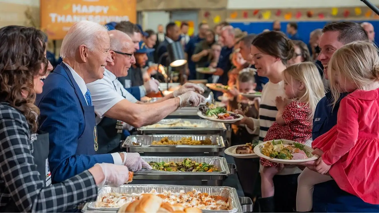 President serving food to Coast Guard members and families at Friendsgiving event in New York.