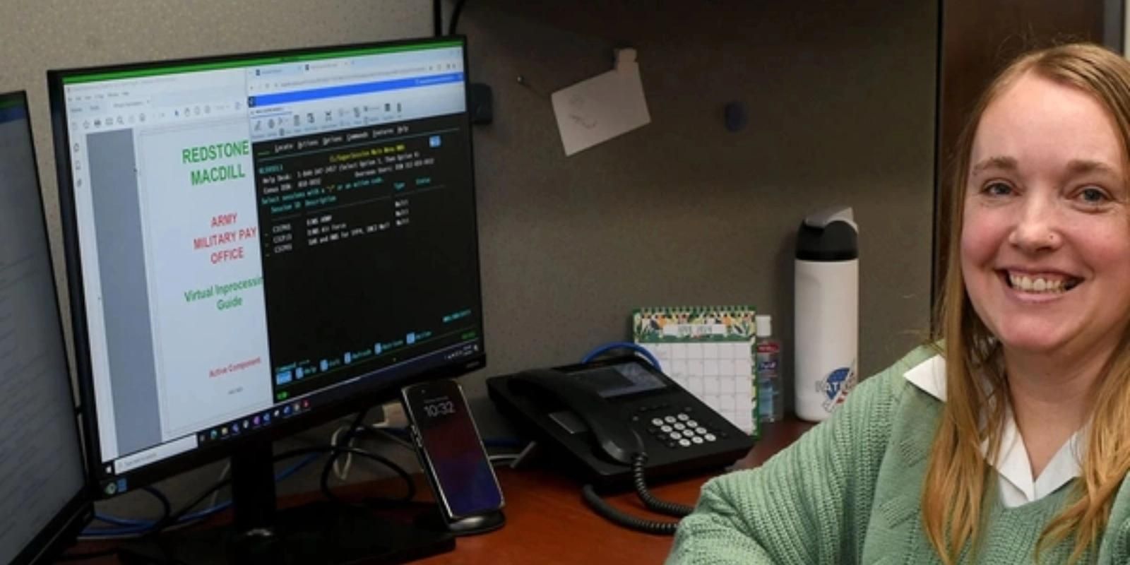 Woman sits at a computer.