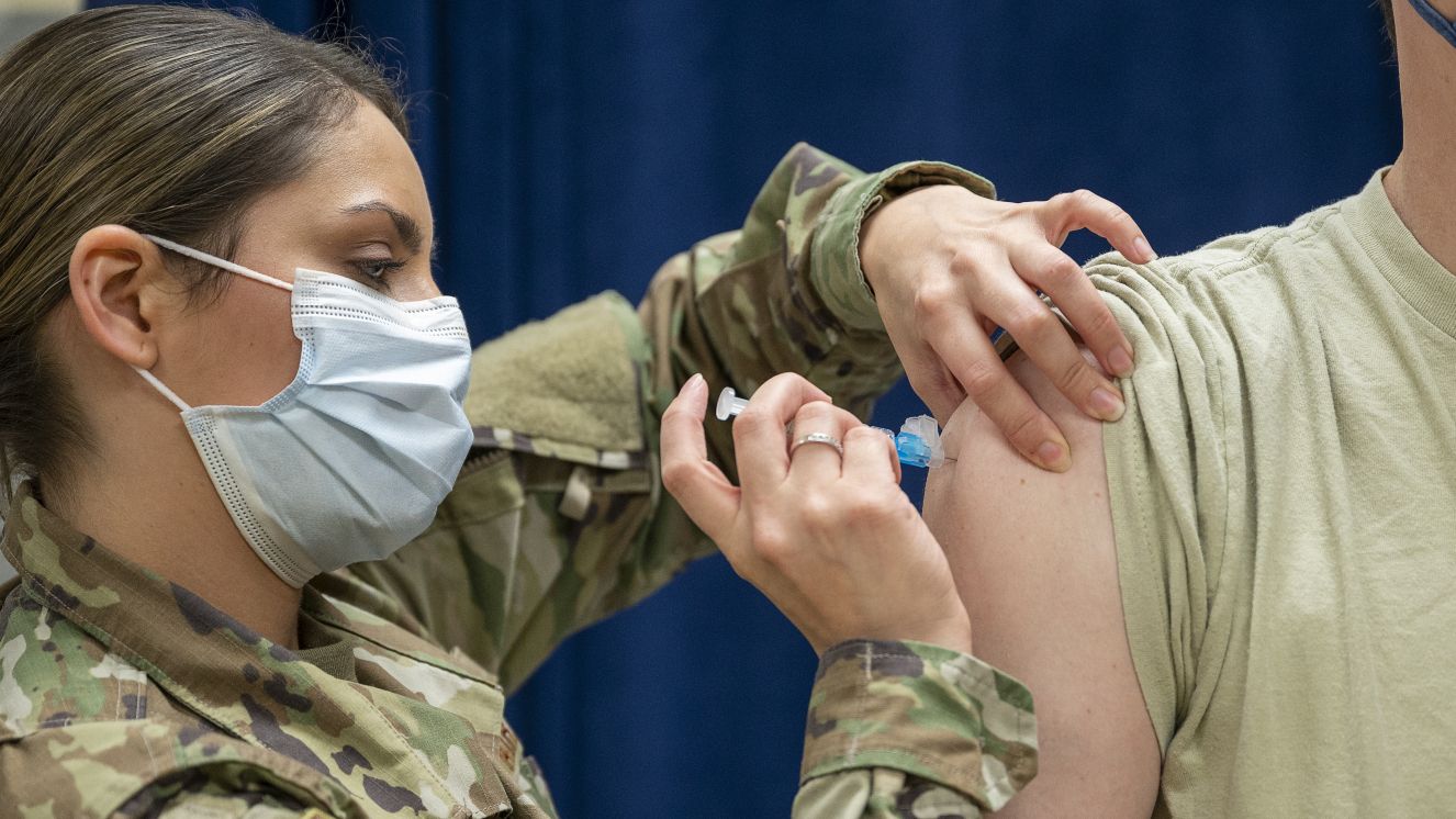 Technical Sgt. Nicole Rodriguez, a medical technician with the 920th Aeromedical Staging Squadron, administers a COVID-19 booster shot Jan. 09, 2022, at MacDill AFB, Fla.