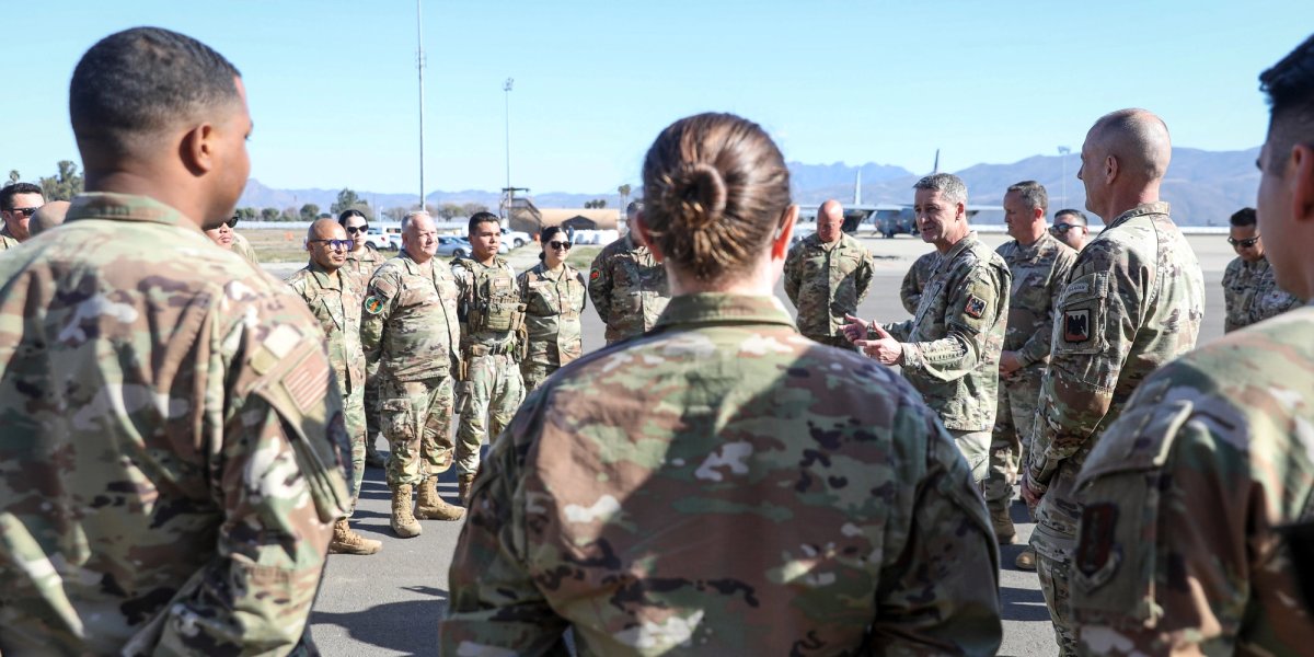 A group of soldiers listens to their instructor.