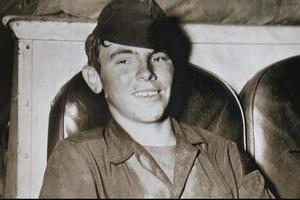 Vintage photo of a young boy in uniform.