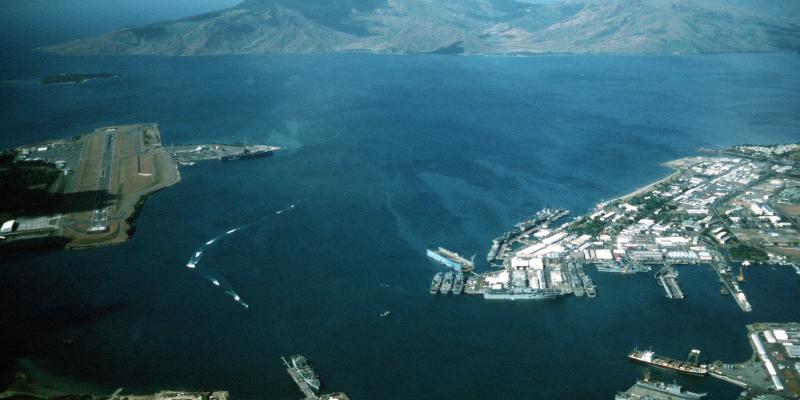 Aerial view of the U.S. Navy Naval Station Subic Bay, Philippines, circa in 1990, with Naval Air Station Cubi Point visible on the left.