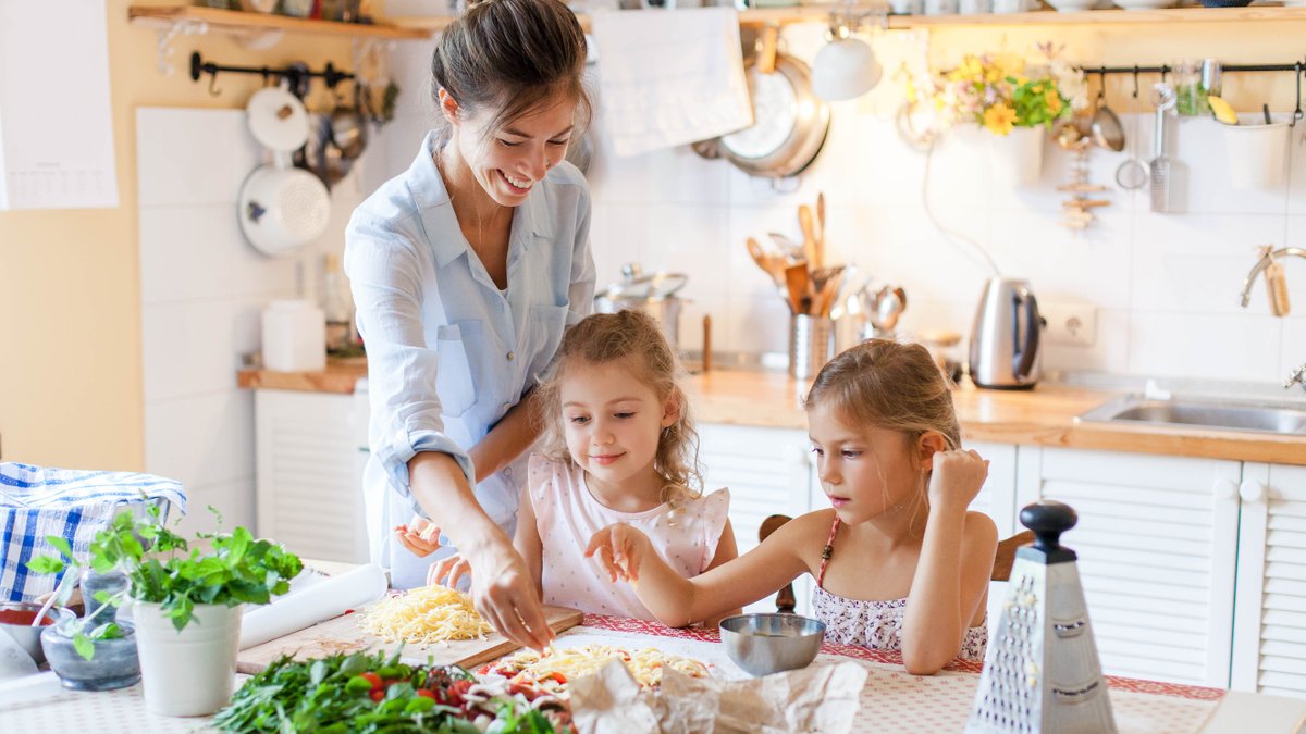 A family cooking together in their home kitchen.