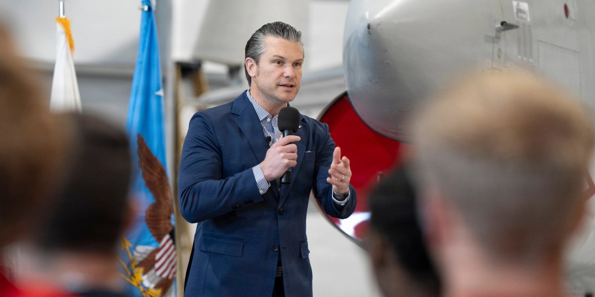 Secretary of War speaks in front of servicemen.