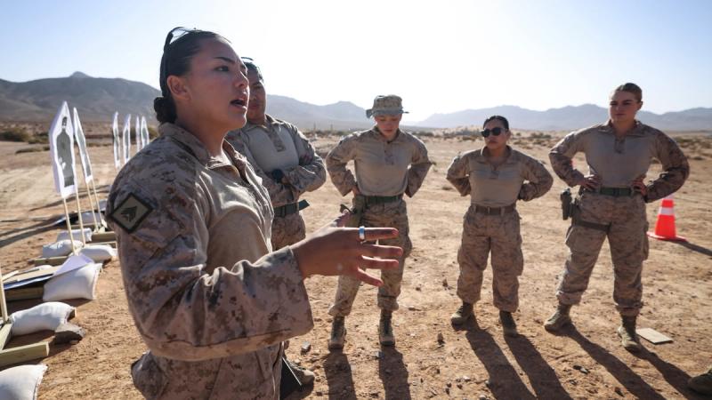 U.S. Marine Corps Sgt. Brianna Eisenhower, left, a combat marksmanship trainer assigned to Weapons and Field Training Battalion, Marine Corps Recruit Depot San Diego, briefs her team prior to an all-female marksmanship subject matter expert exchange between U.S. Marines and Jordanian Soldiers during Intrepid Maven 25.1 in Al-Quwayrah, Jordan, Oct. 29, 2024. 