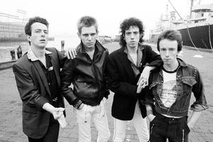 Vintage photo of the band The Clash outdoors.