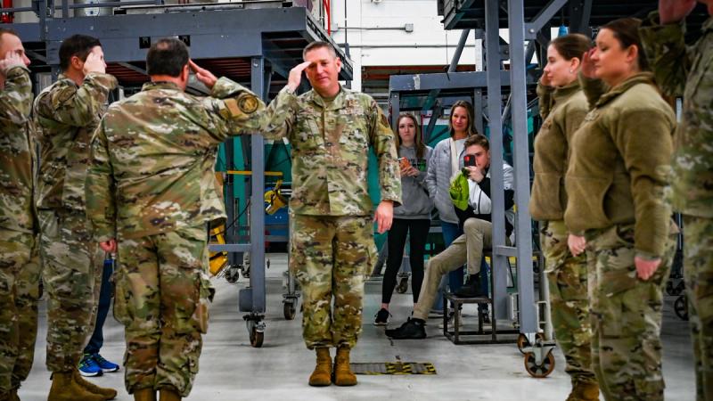 U.S. Air Force Lt. Col. John Mims, deputy commander of the 165th Maintenance Group, gives a final salute to their outgoing commander, Col. Steven Poulos, on his final day of work prior to his terminal leave.