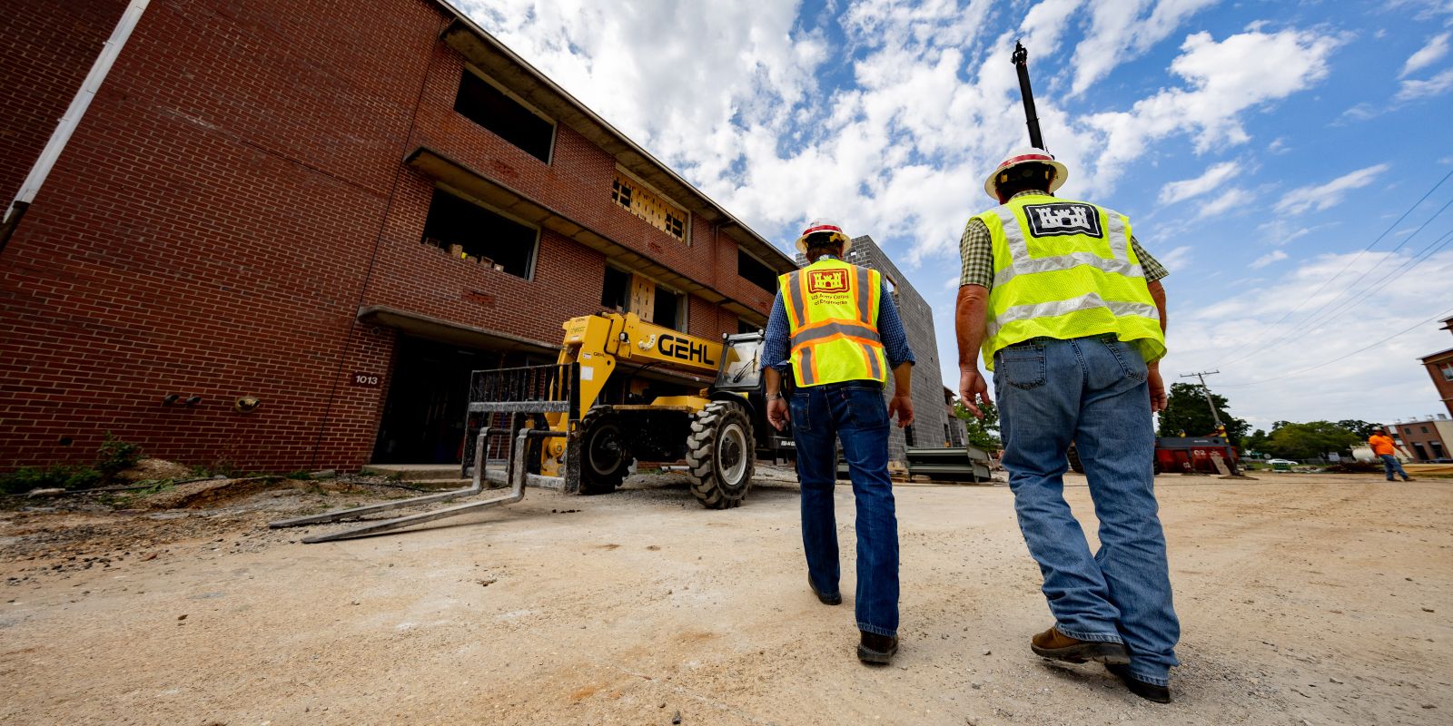 Wes Safarik (left), FLW area office resident engineer, and Brad Slone (right), engineering technician, walk the AIT barracks renovation site at Fort Leonard Wood.