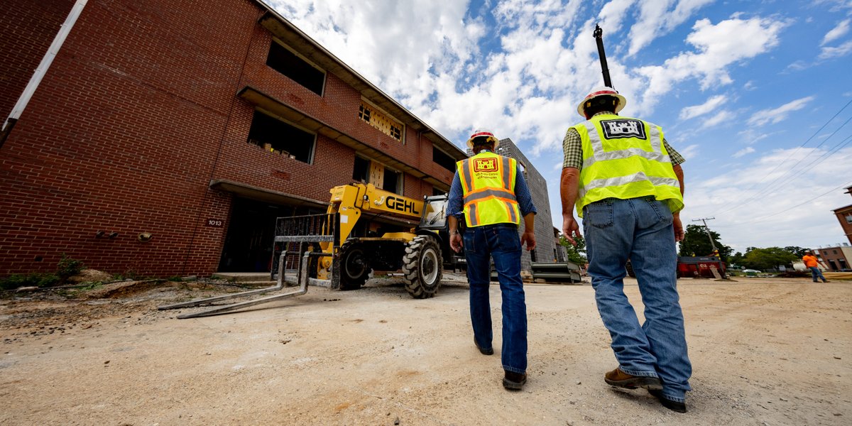 Wes Safarik (left), FLW area office resident engineer, and Brad Slone (right), engineering technician, walk the AIT barracks renovation site at Fort Leonard Wood.