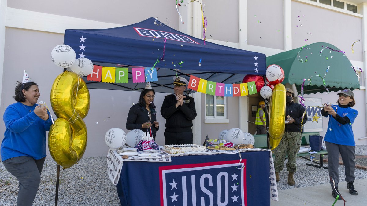 A group of people celebrate the USO birthday.