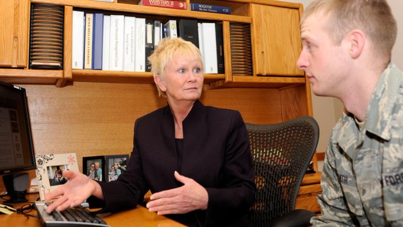 Dawn Hemming-Rich, 28th Force Support Squadron Education Office education and training section chief, explains the process for transferring Post 9/11 GI Bill benefits to family members to Staff Sgt. Keith Smith, 28th FSS resource advisor, in the base Education Office at Ellsworth Air Force Base, S.D., Jan. 24, 2013. 