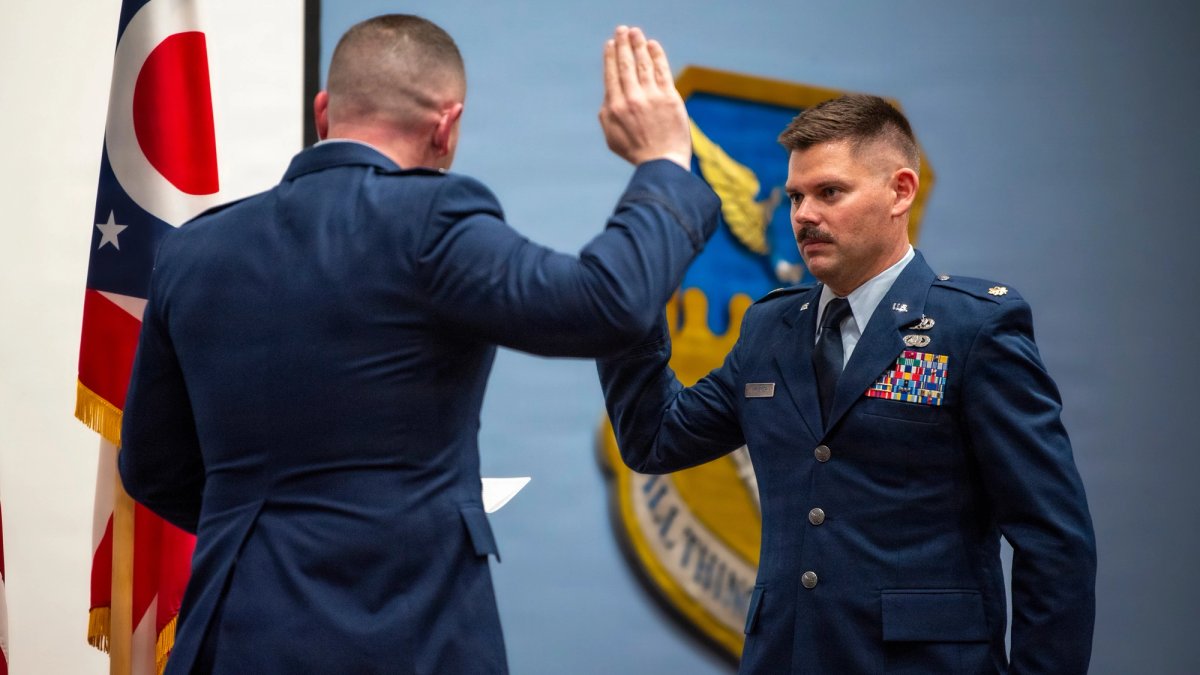 An airman is sworn in at a promotion.