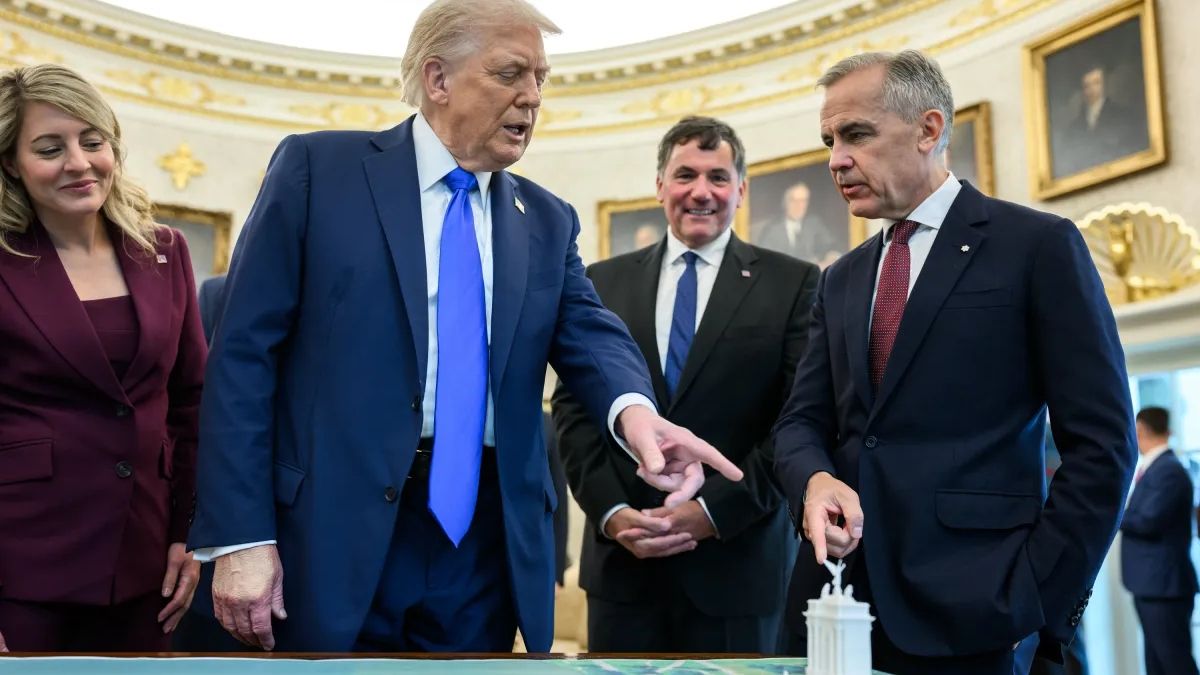 Pres. Trump points to a miniature model of a proposed new monument for DC.