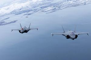Two fighter jets fly in formation.
