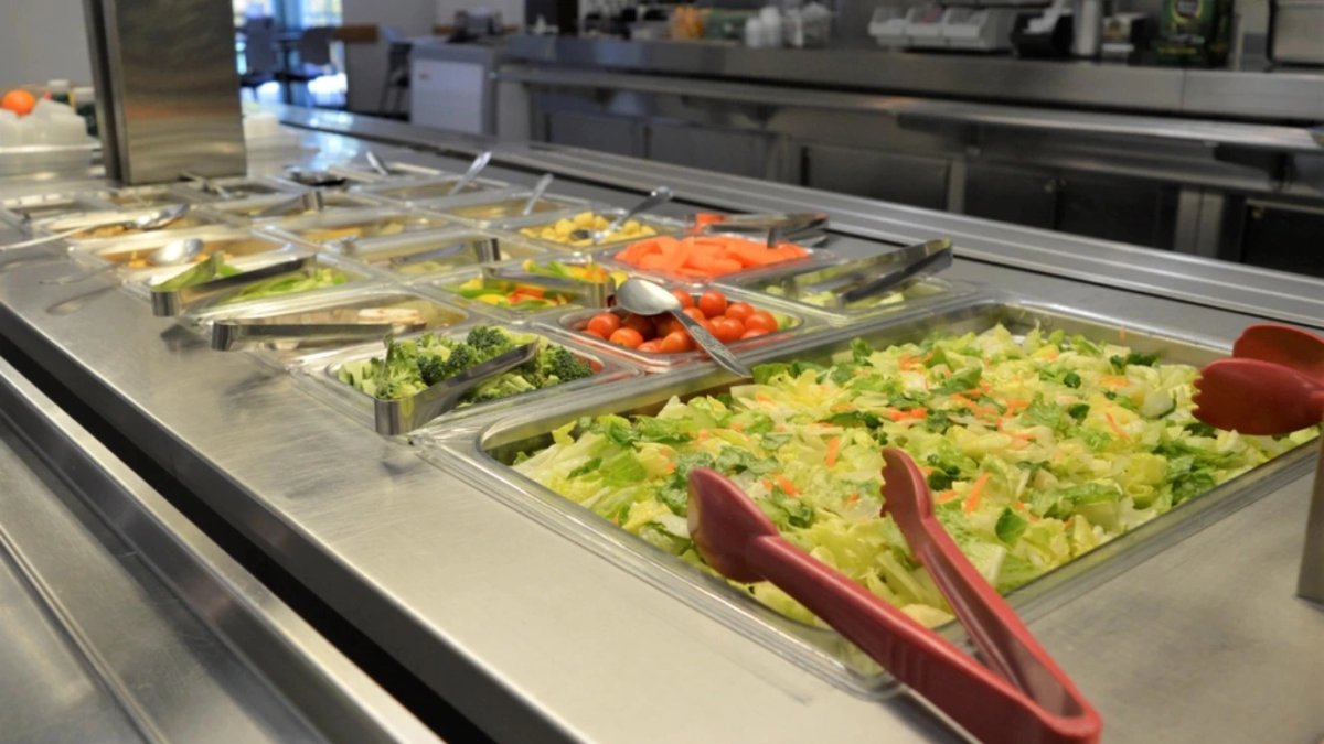 Salad bar with fresh vegetables at military base dining facility.