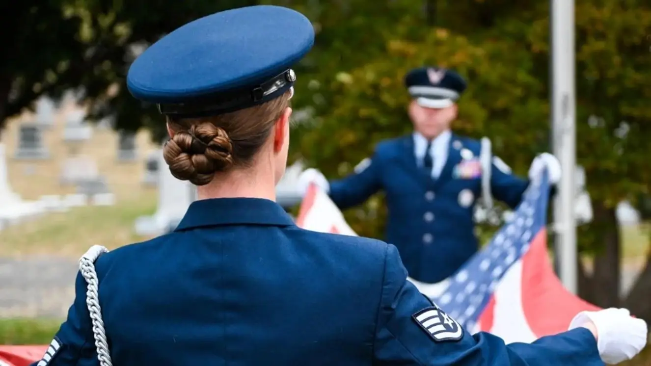 Soldier folding a flag.