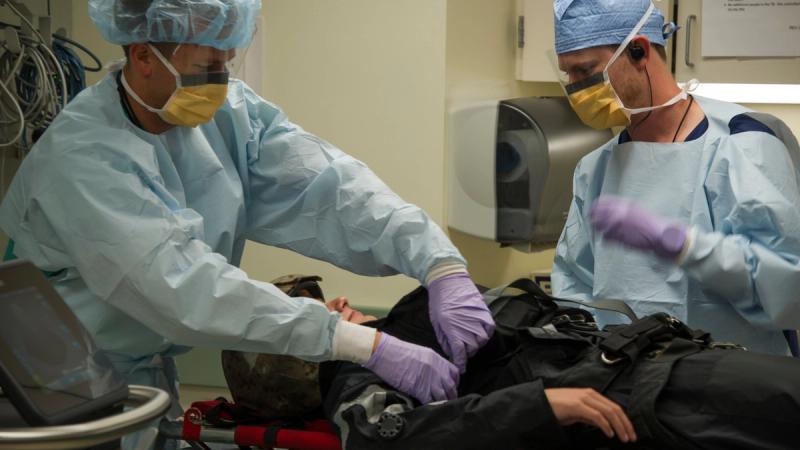 Doctors from Sentara Norfolk General Hospital simulate treating a critically wounded patient in support of a Search and Rescue Exercise (SAREX) with Sailors assigned to Helicopter Sea Combat Squadron (HSC) 2. 