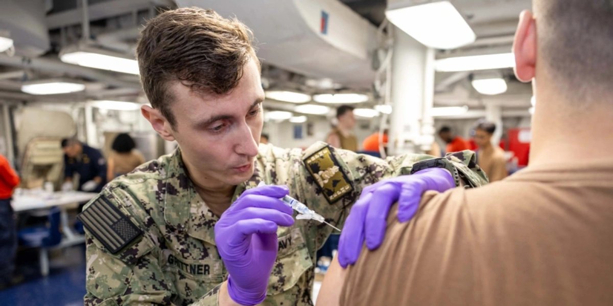 Hospital Corpsman 2nd Class Cole Grittner, a native of Medical Lake, Washington, administers a flu shot aboard the Nimitz-class aircraft carrier USS Harry S. Truman.
